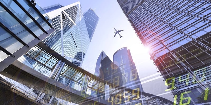 Plane flying over Hong Kong's financial district with stock prices overlay