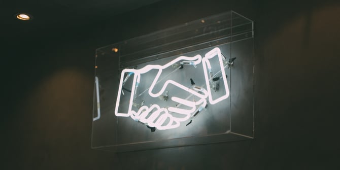 neon sign shaking hands