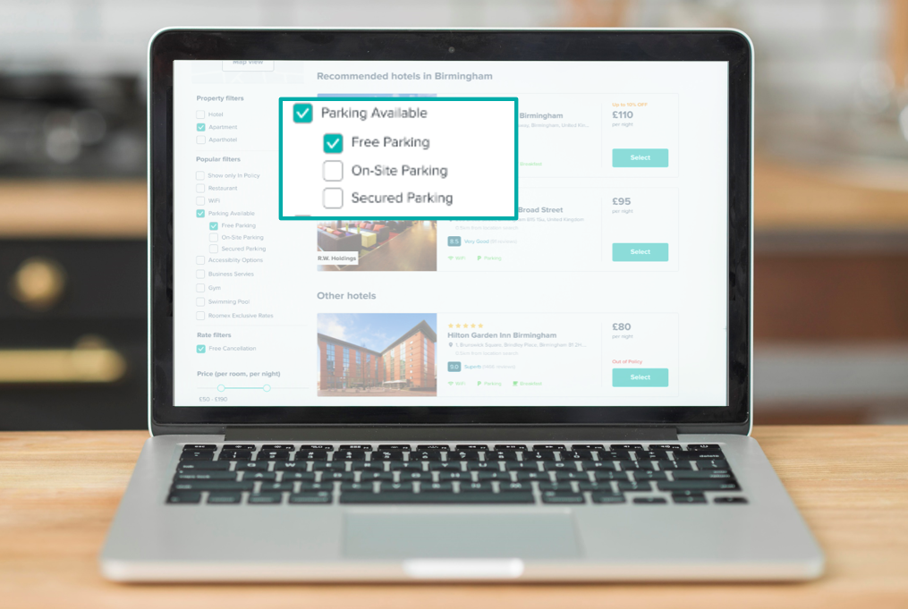 Laptop with screengrab of Roomex platform showing free parking filter