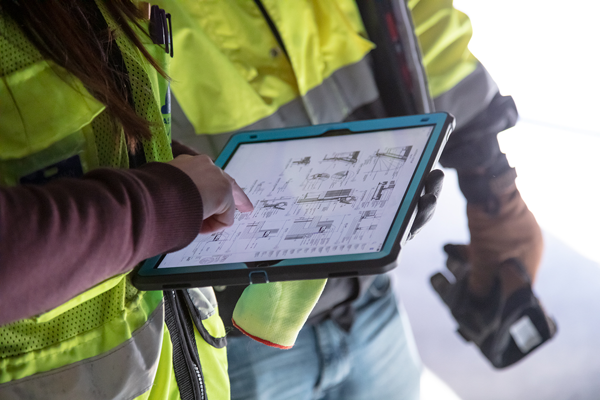 Construction workers using Autodesk on a tablet