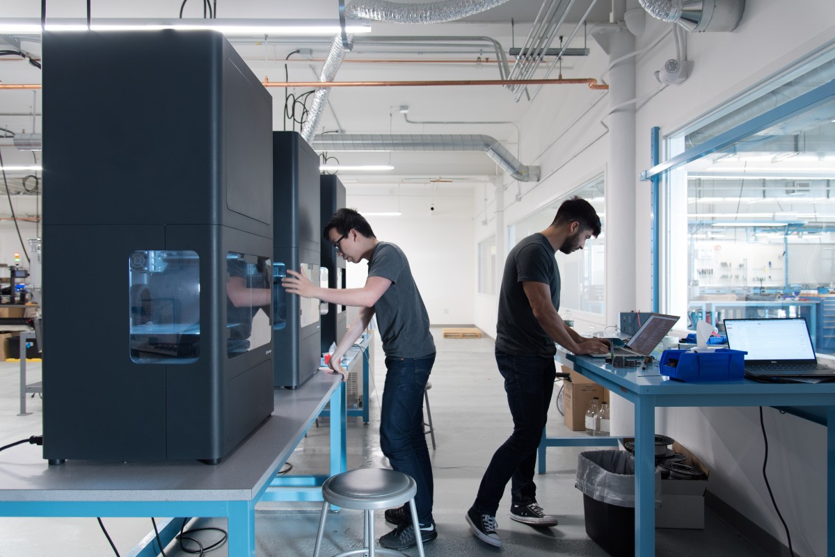 Two men working with Markforged 3D Printers - TPM