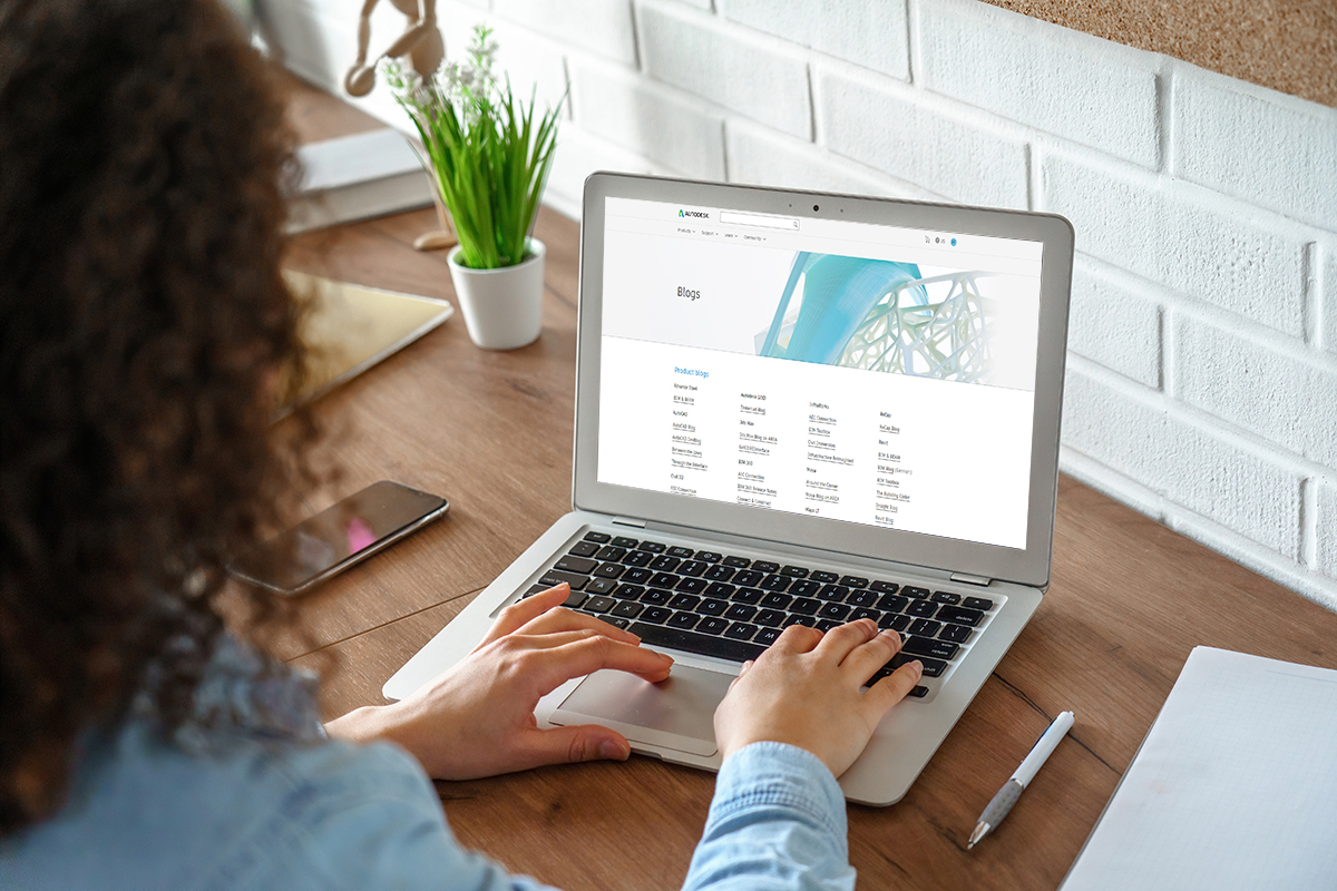 Woman on Autodesk Blog website on a laptop computer