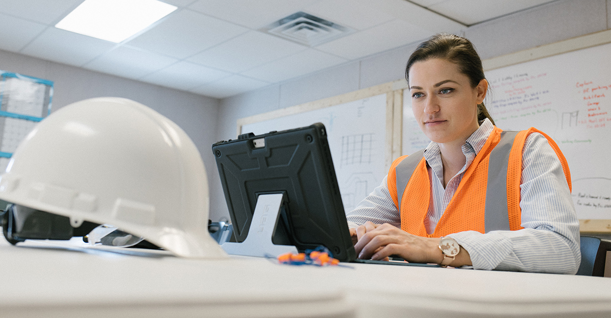 A female construction worker on a computer