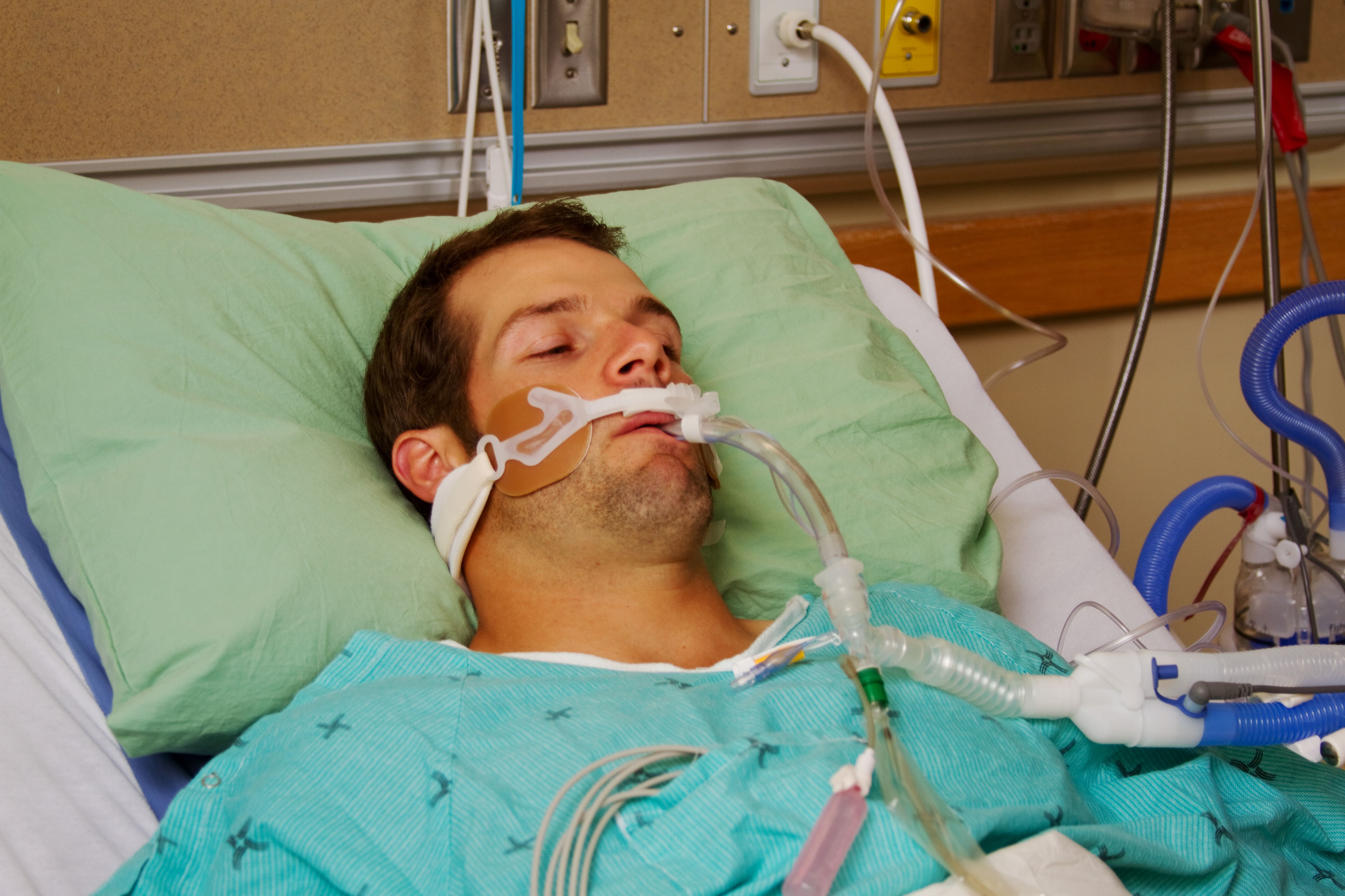 Man in bed with ventilator