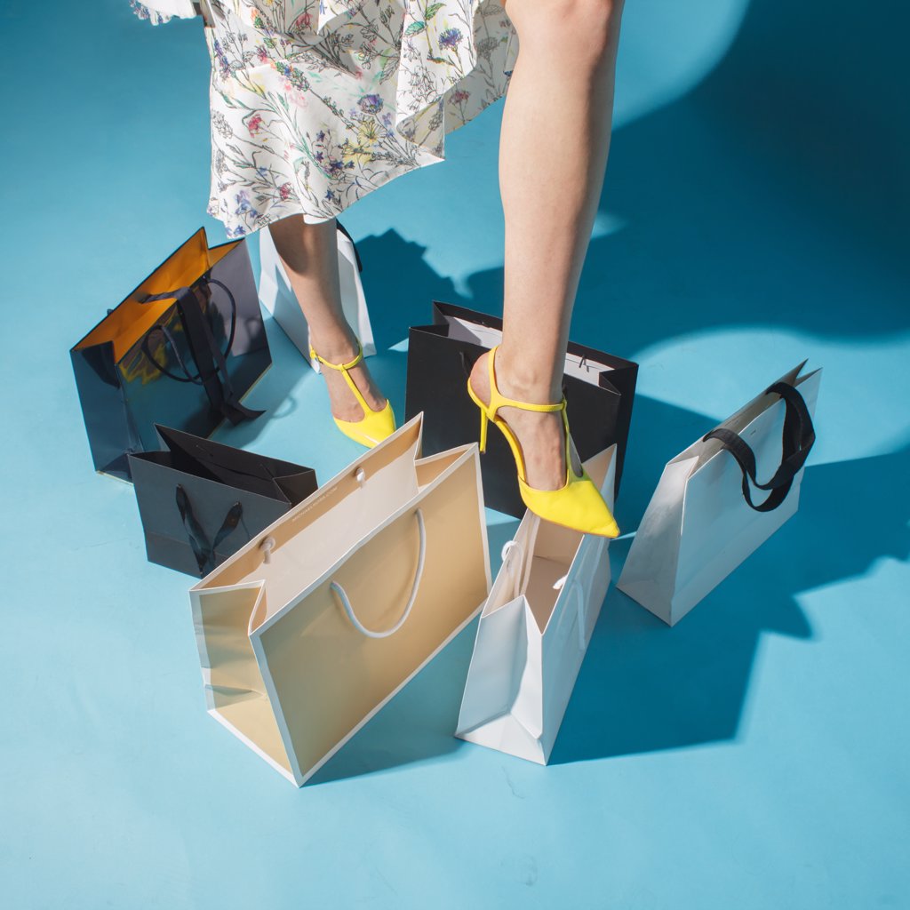 WOMAN LEG IN FASHION SHOE OVER SHOPPING BAGS