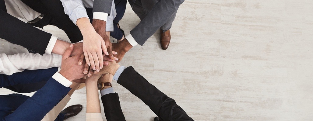 photo of professionals with hands together