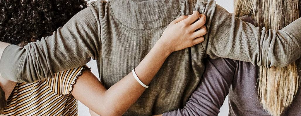 photo of people with their arms around each other