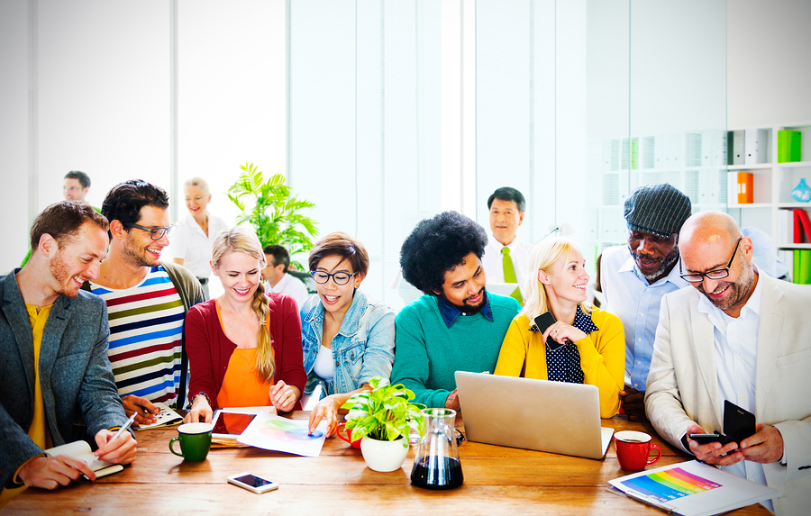 BS Diverse workers discussing at table