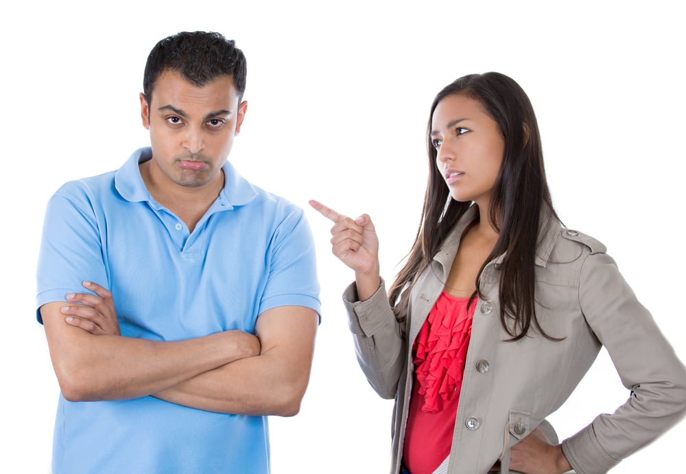 Closeup portrait of woman pointing at man as if to say bad boy because he did something wrong, isolated on white background