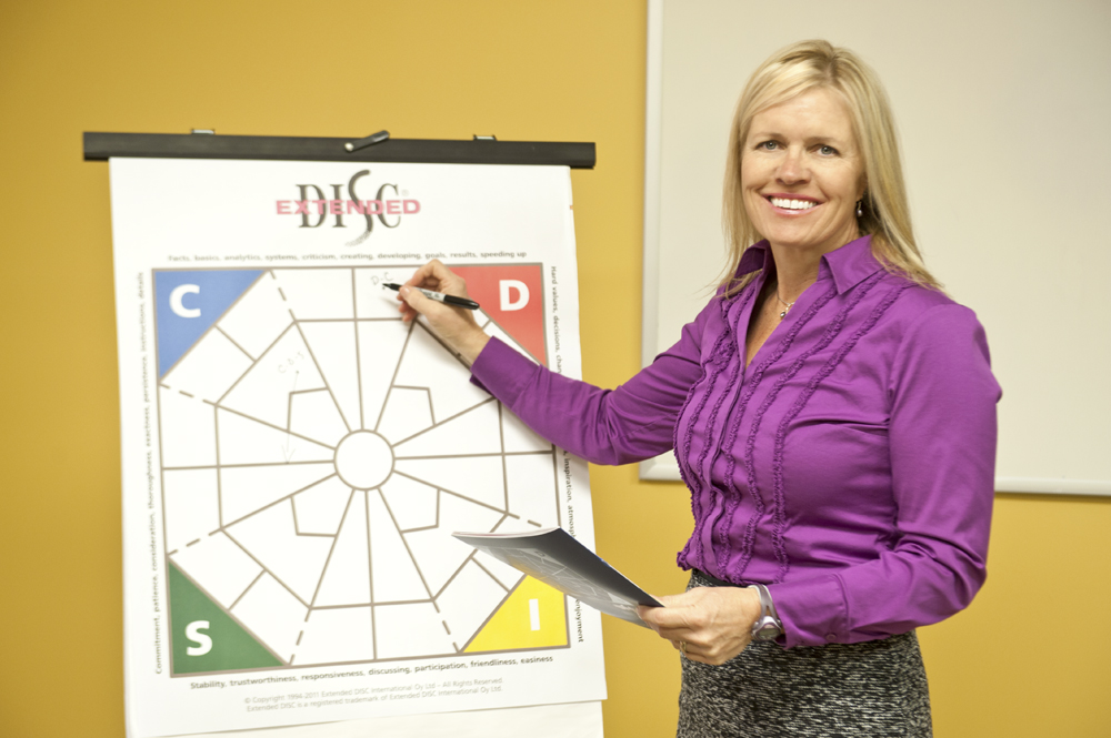 Extended DISC Facilitator Trainer in front of  DISC Diamond Chartpad