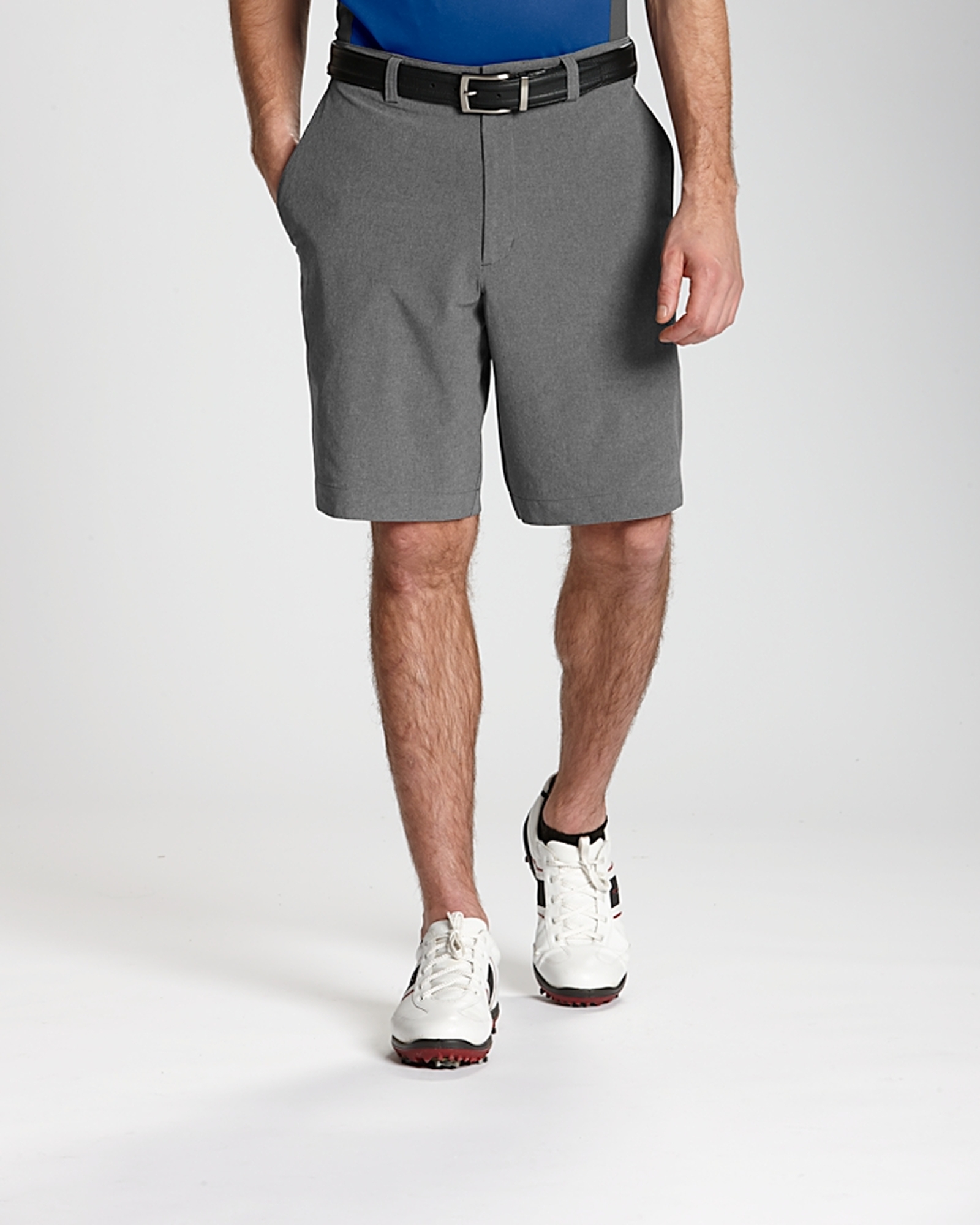 Man wearing sneakers and Cutter & Buck Bainbridge Flat Front Short in Grey