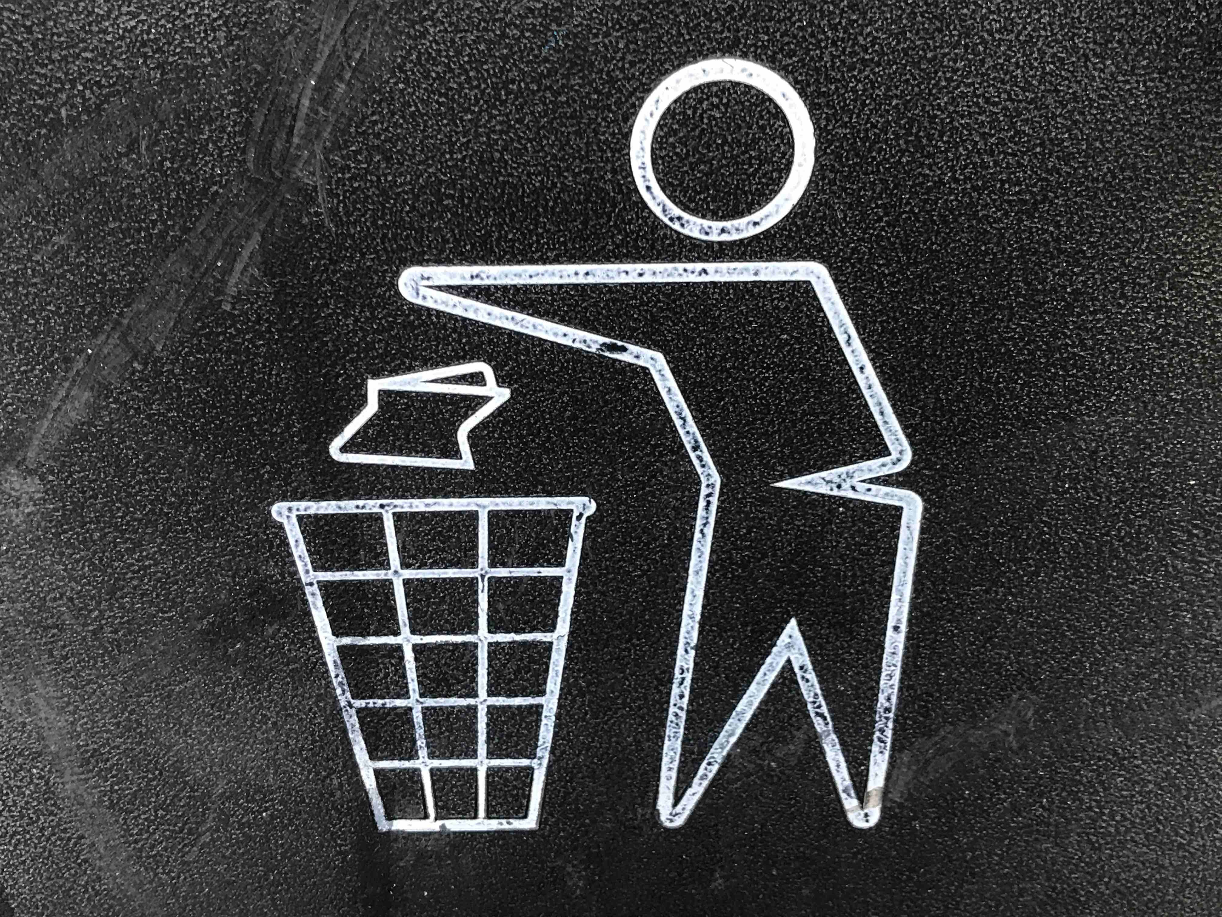 Drawing of person discarding trash in a recycle bin