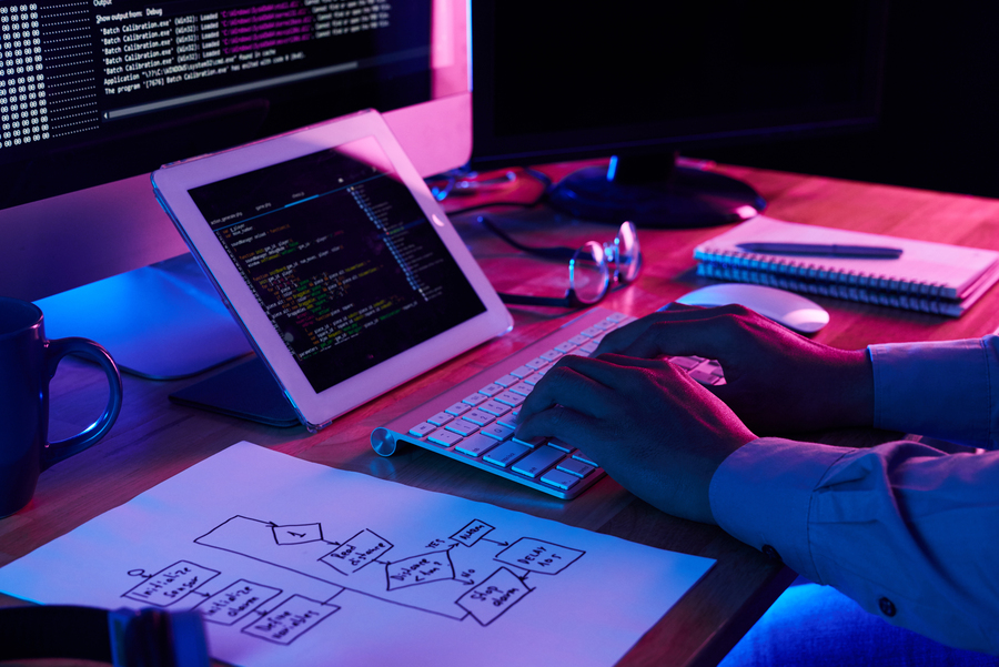 close-up-image-of-programer-working-at-his-desk-in-office
