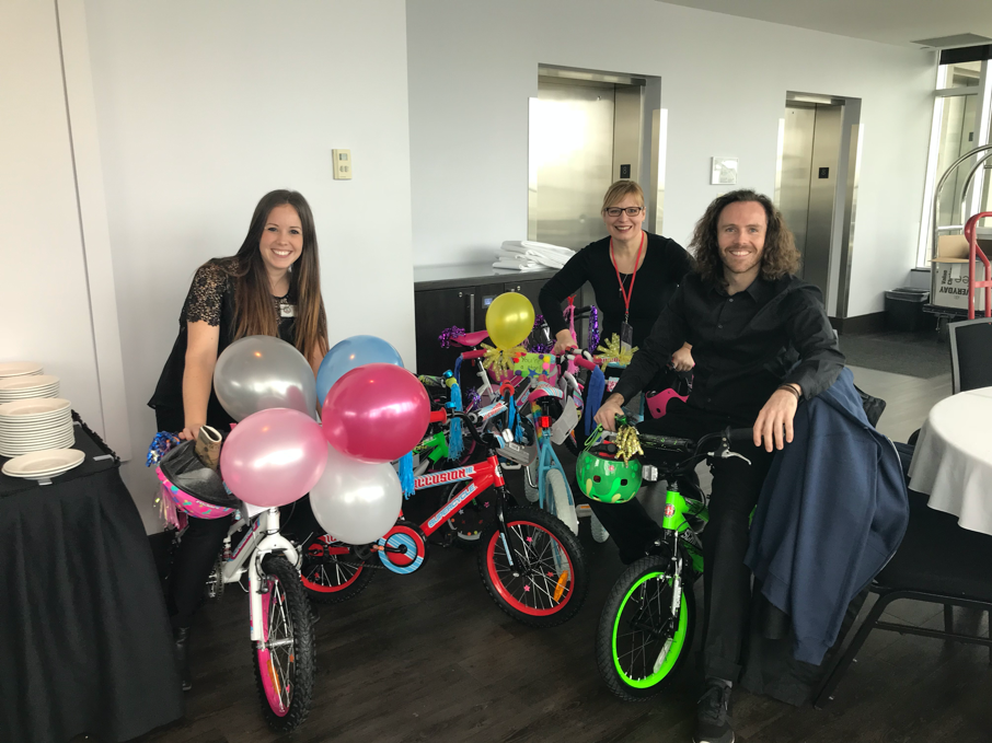 employees doing a charity bike buildathon team building activity 