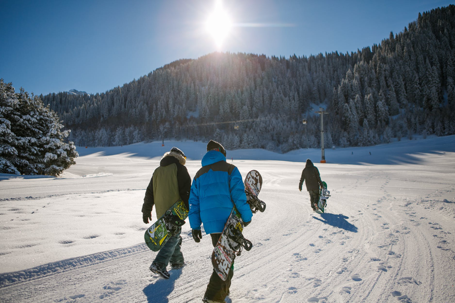 some colleagues with snowboards doing winter team building in the great outdoors 