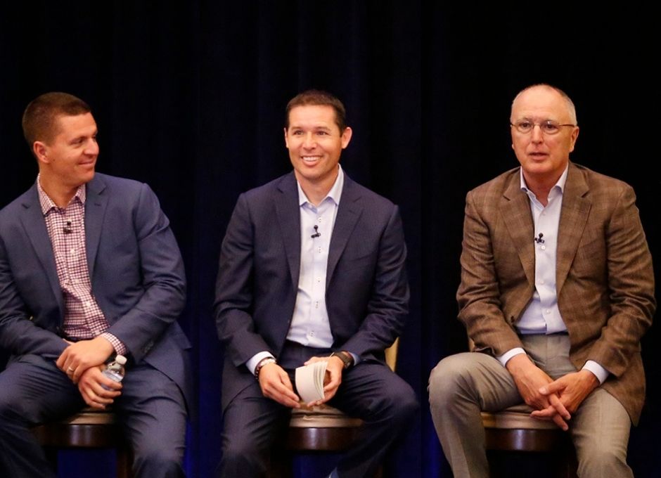 clothiers seated on stage at conference
