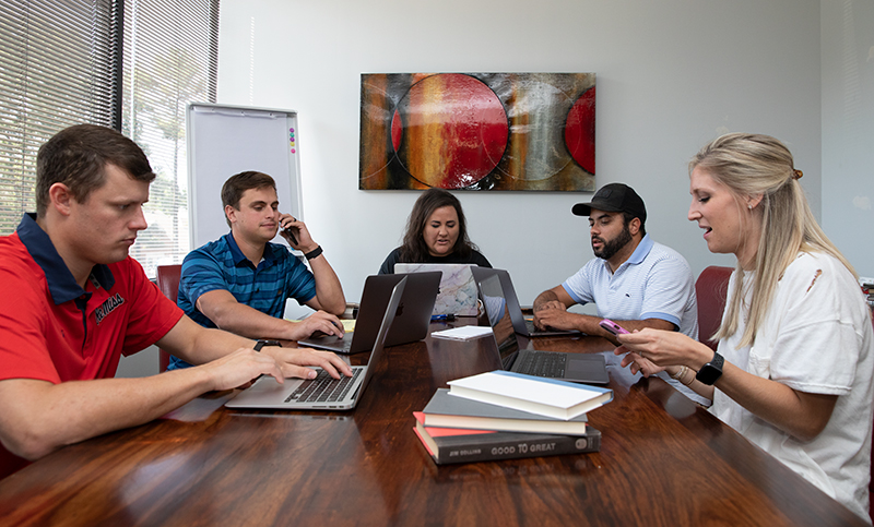 ppmg team at table in meeting