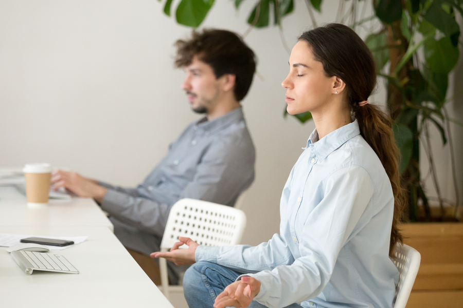mindful-calm-young-woman-taking-break-office-meditation