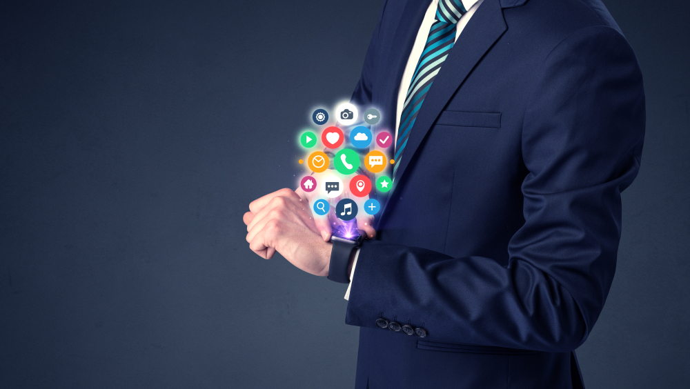 Businessman wearing smartwatch with colored application symbols on it.