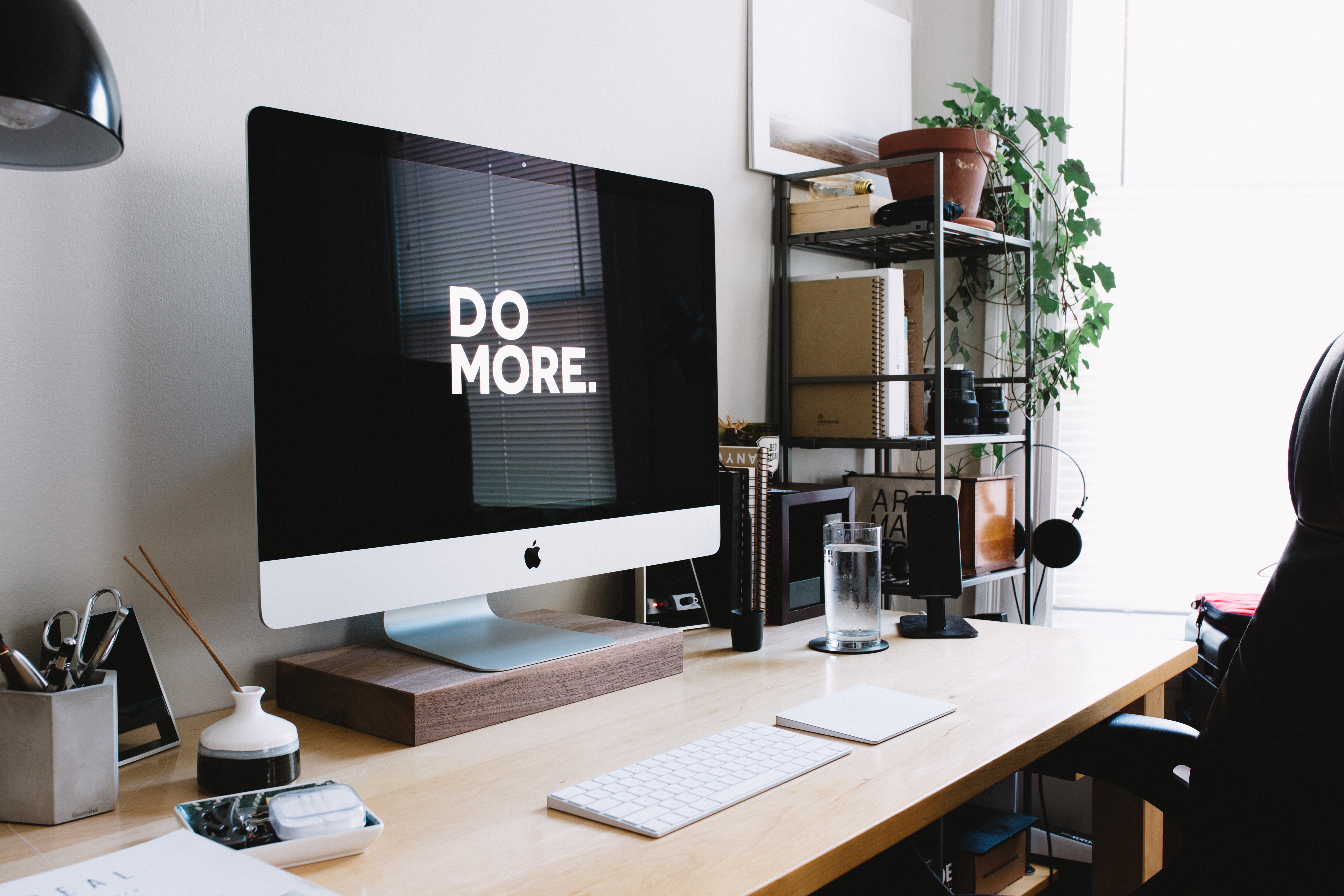 screensaver displaying 'Do More' on organized home office desk