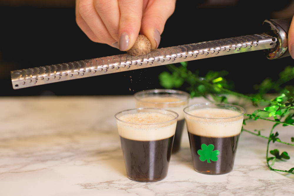 grating nutmeg over irish coffee jello shots