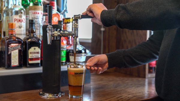 Stout being poured over Black & Tan Spoon