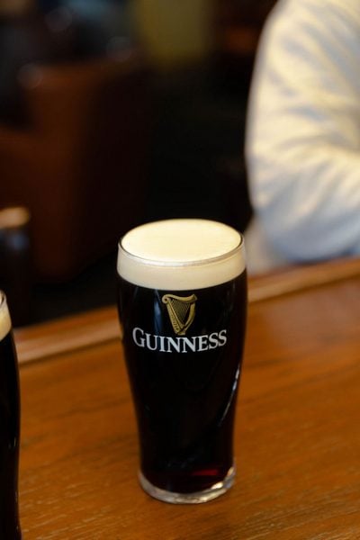 Top off your pint by pushing the tap handle from you. This limits the power of the flow. The beer should be set straight under the spout during this second pour.