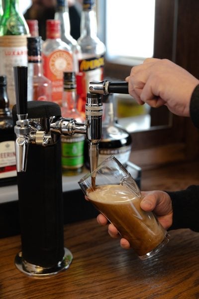 Pull the spout toward you and pour until the glass is ¾ full (to the top of the harp logo).