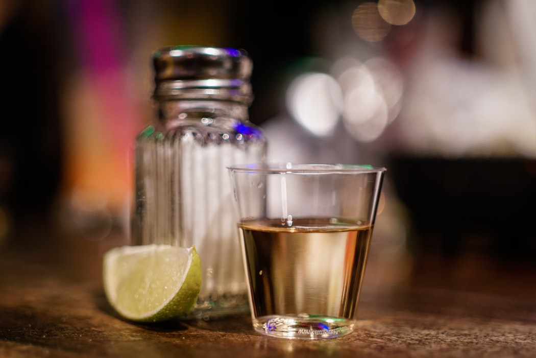 tequila shot with salt and lime wedge