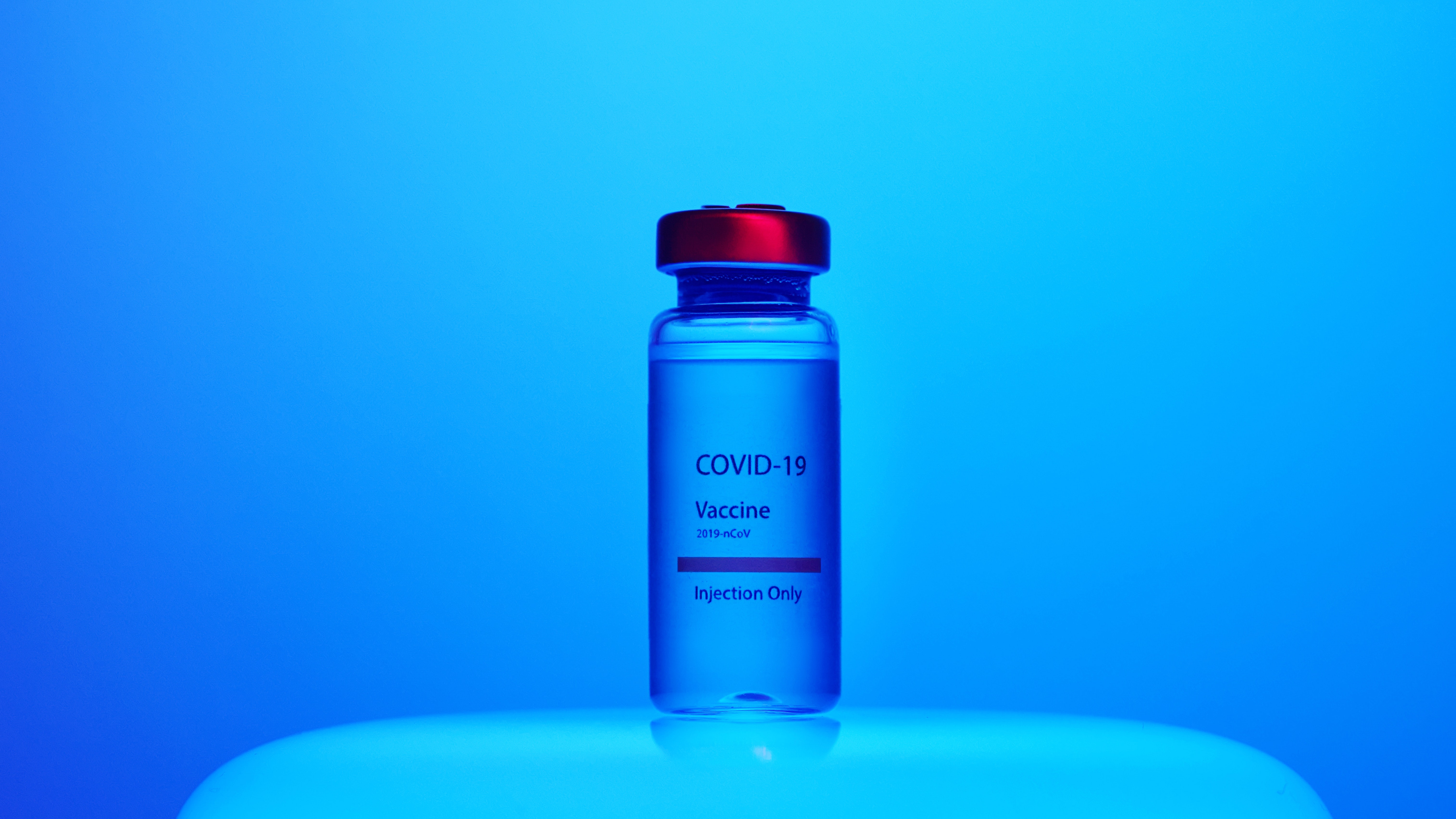 covid-19-vaccine-injection-in-bottle-with-blue-background