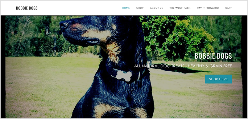 Bobbie Dogs website homepage with a large banner image of a black and tan dog.