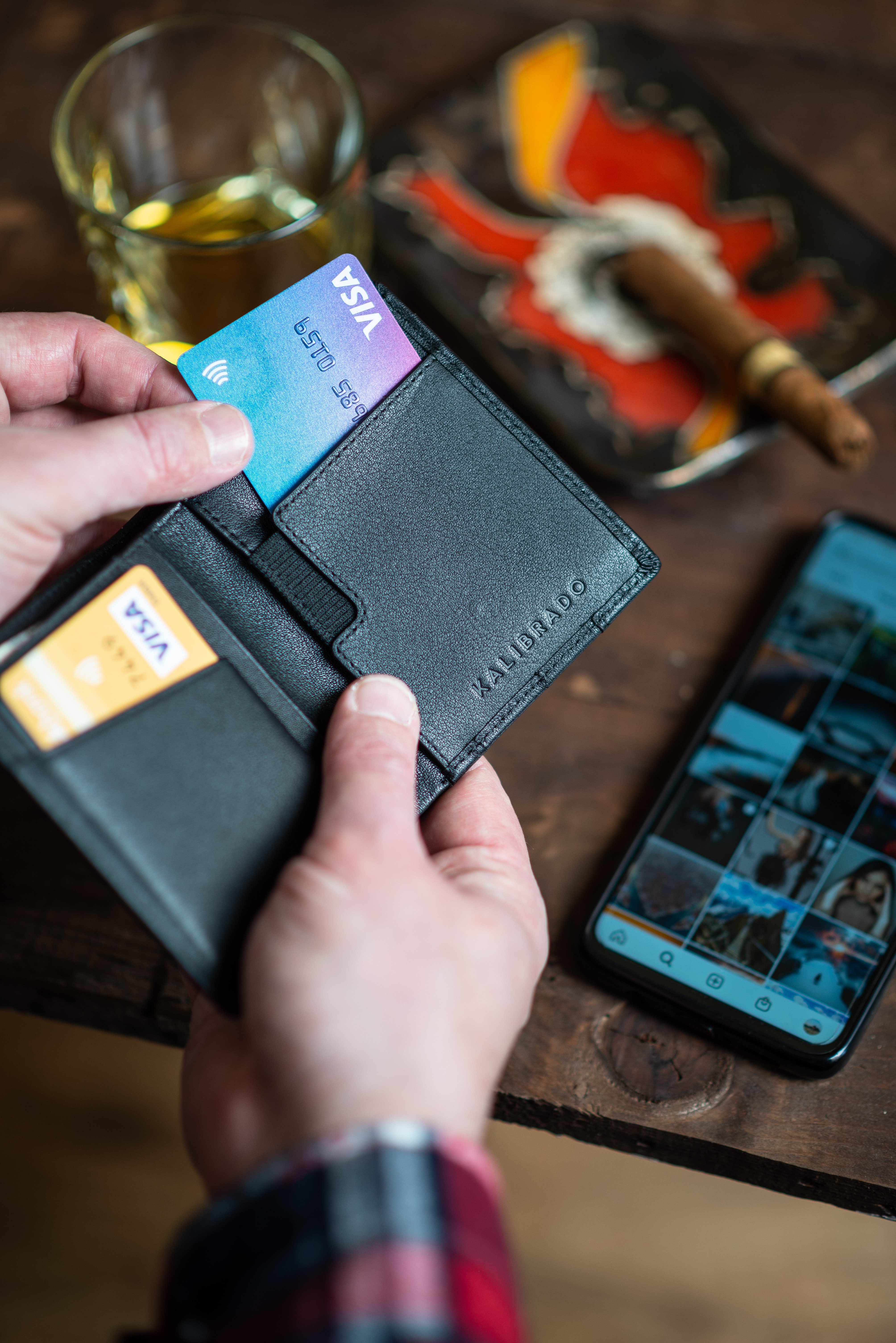 Image of a wallet with two visa cards inside.