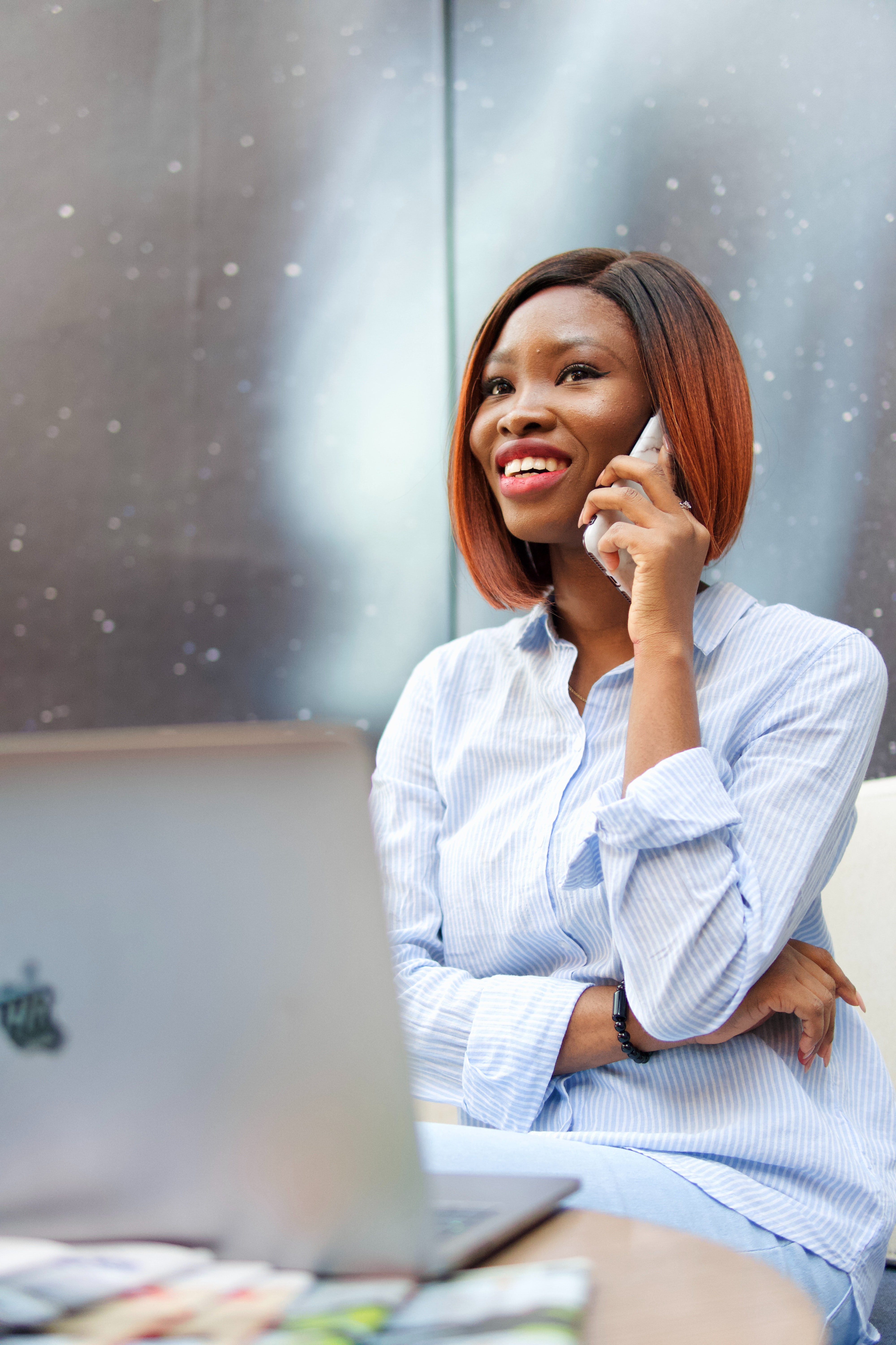 Image of a businesswoman or merchant on the phone looking happy