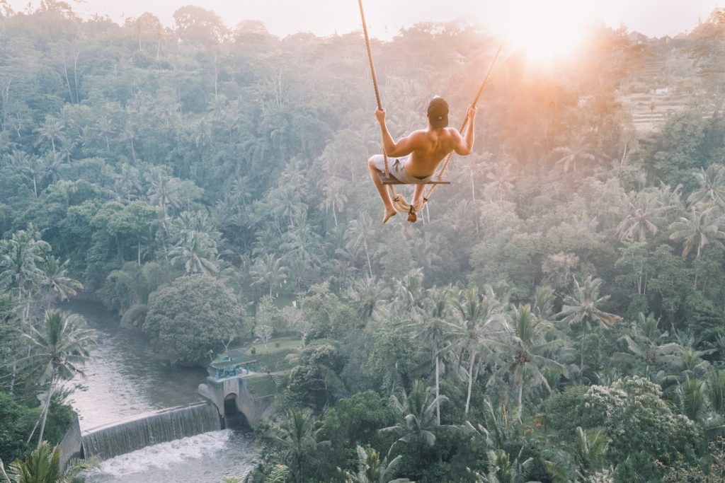 Man swinging in the jungle making him the ideal TripMate