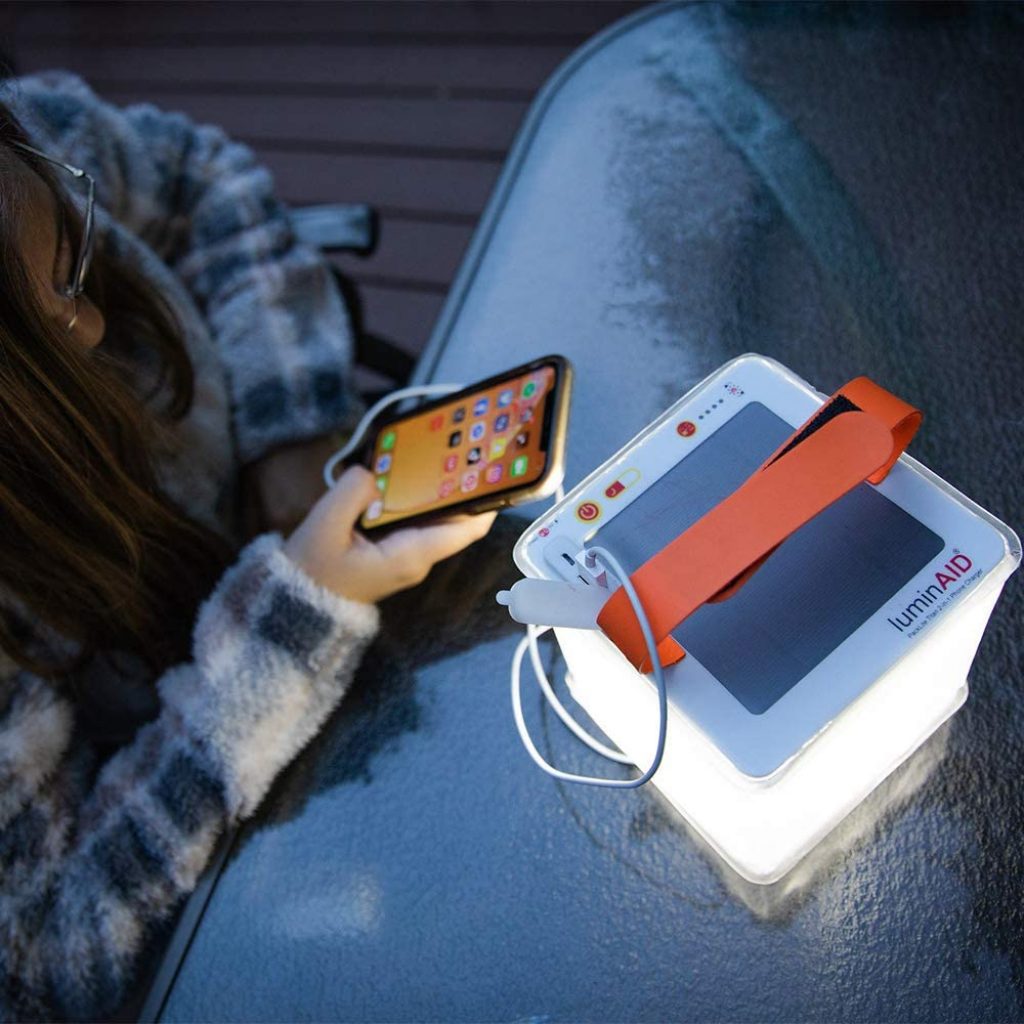 A girl uses her LED lantern during her camping trip.