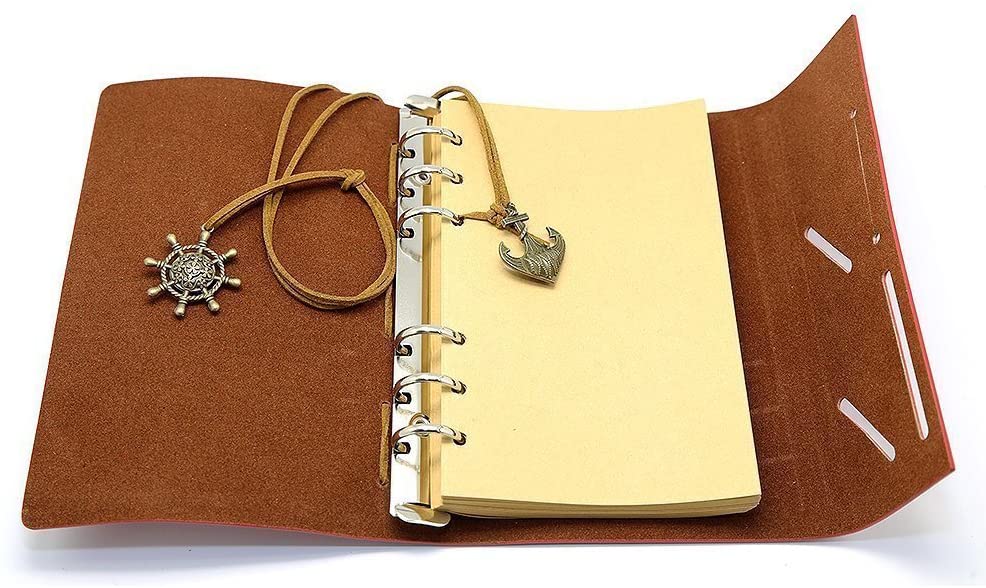 A brown faux leather travel diary as a travel essential on an adventure trip.