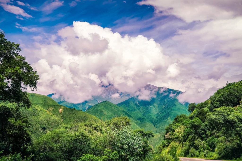 Beautiful picture of the mountainous landscapes of the Andean landscape with white clouds above the green mountains