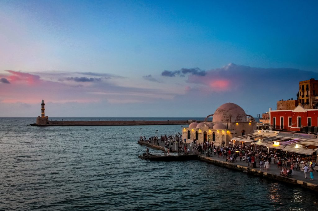 the old city of Chania  overlooking the sea in the evening with little lights everywhere and the famous lighttower 