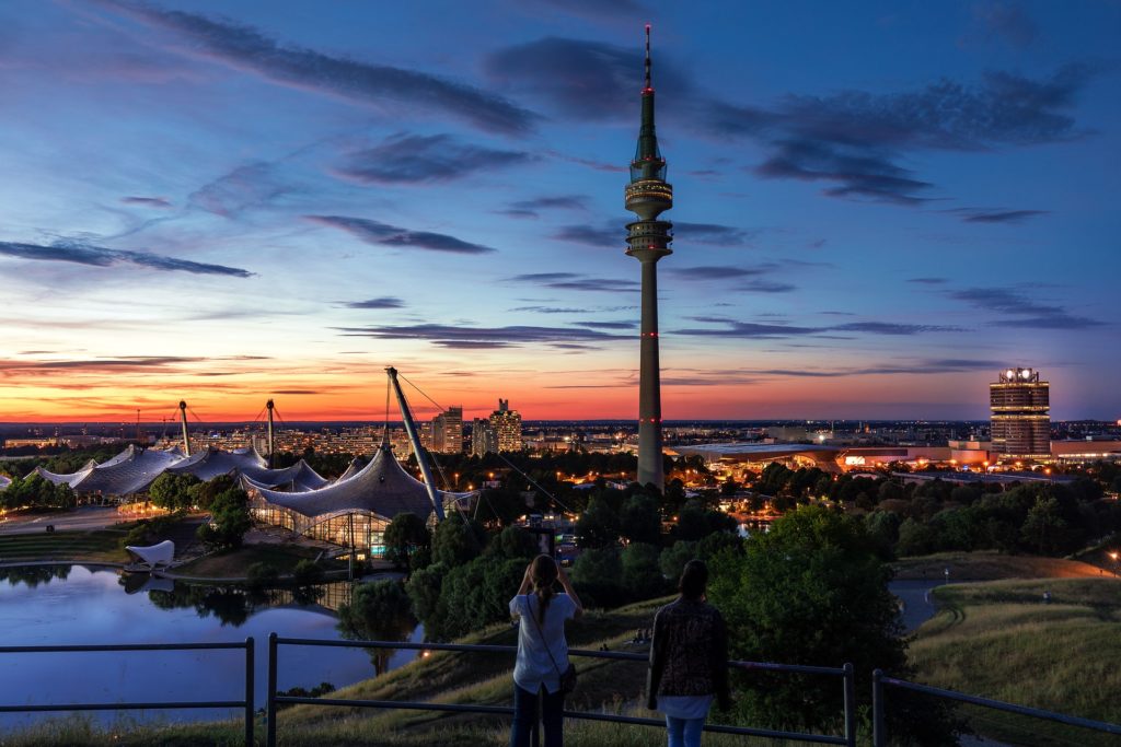 Two people in Munich overlooking the city from above during the sunset