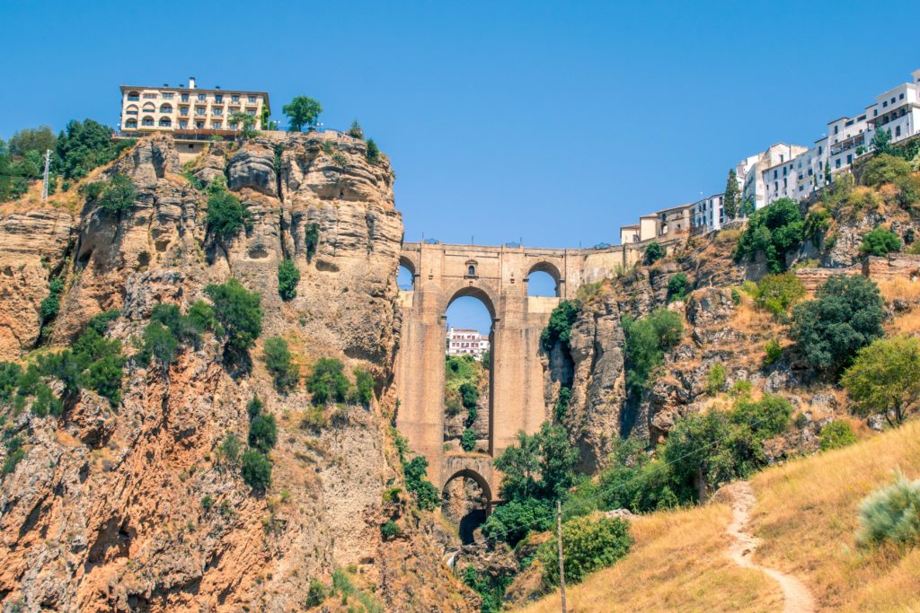 City of Ronda in Spain with a view of the stone bridge and high cliffs perfect summer destination in 2020