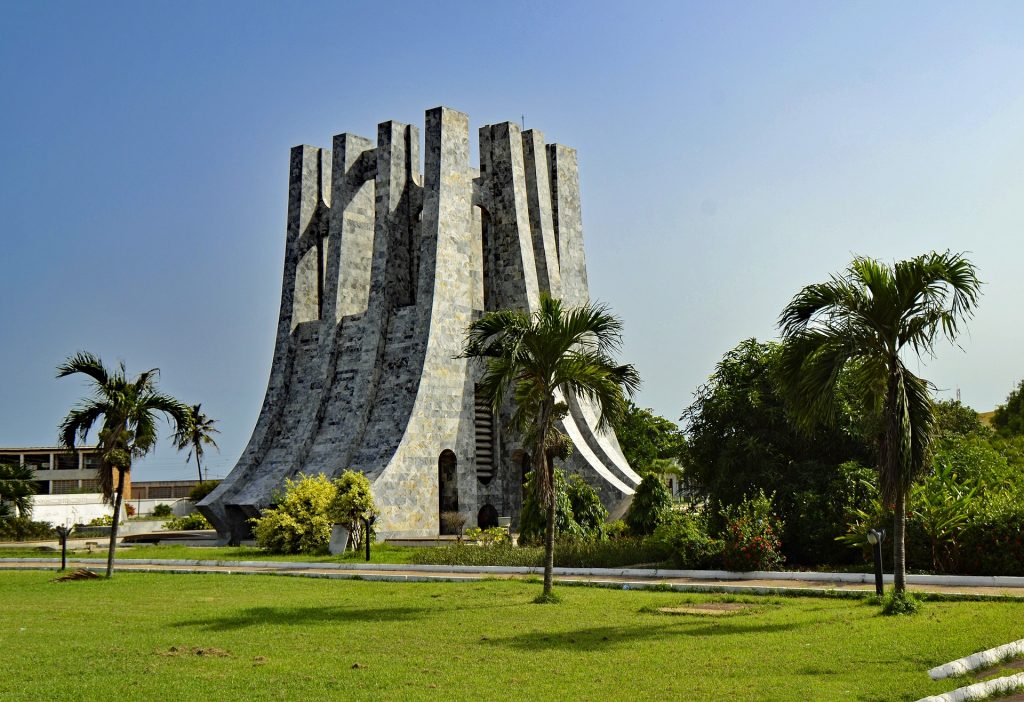 Kwame Nkrumah Memorial Park in Ghana with green grass and trees in the day time with blue sky.