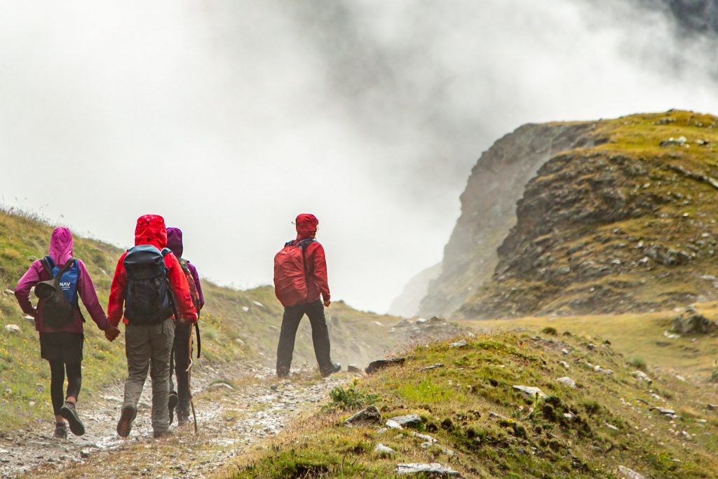 a group of people hiking with backpacks on. 