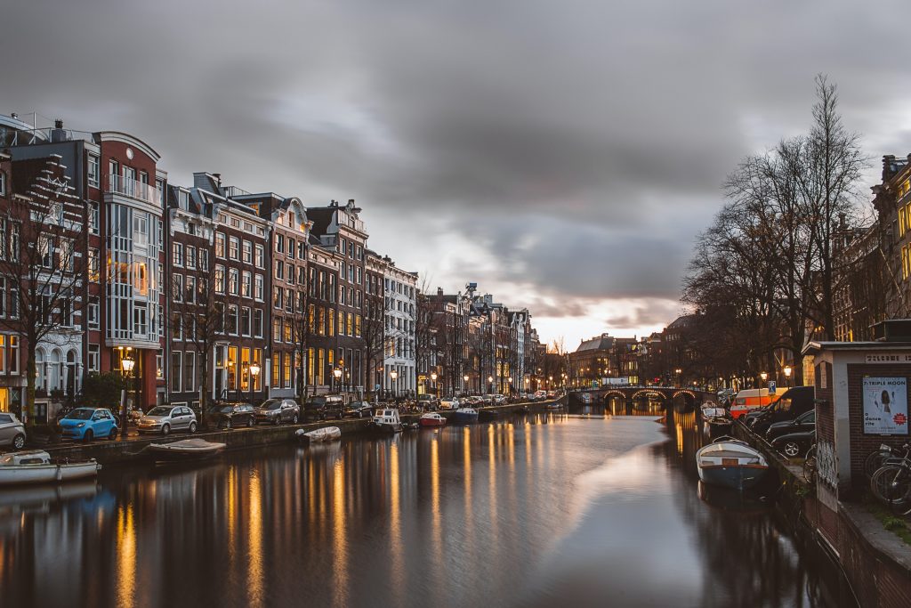 Valentine’s Trips For Singles in Amsterdam, Netherlands with a view of the canal and foggy sky.