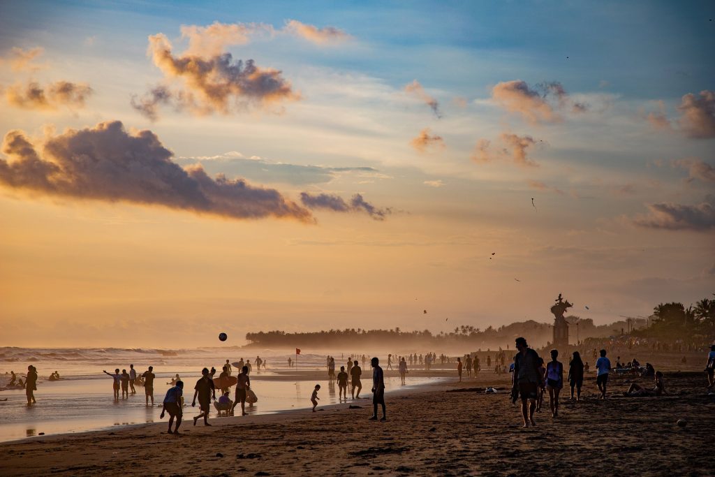 lots of people at sunset on the beaches of Bali, one of the best surf spots in the world