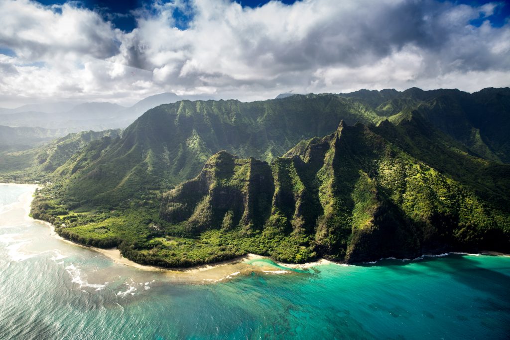 Na Pali Coast in Hawaii with turquoise blue sea and green mountains making it one of the most beautiful places in the world.