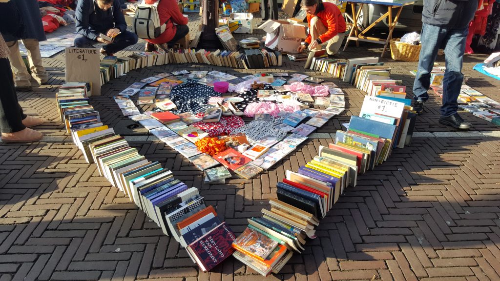 Waterlooplein flea market in Amsterdam with books arranged in a heart shape.