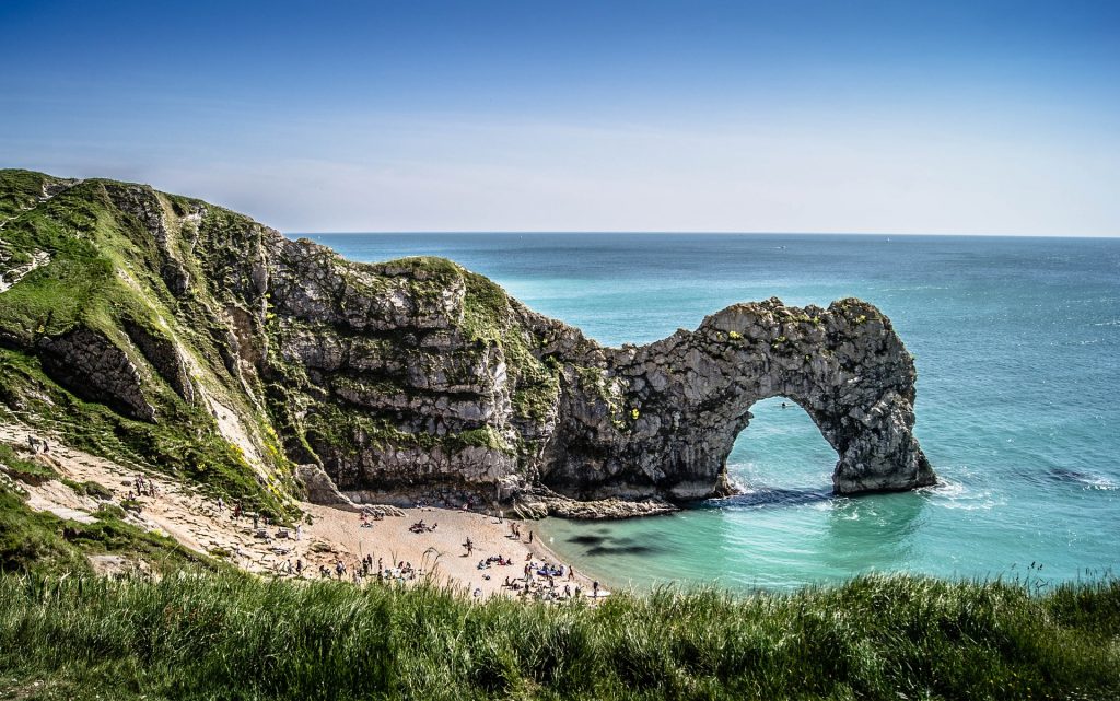 Beach with rock structures and people in England