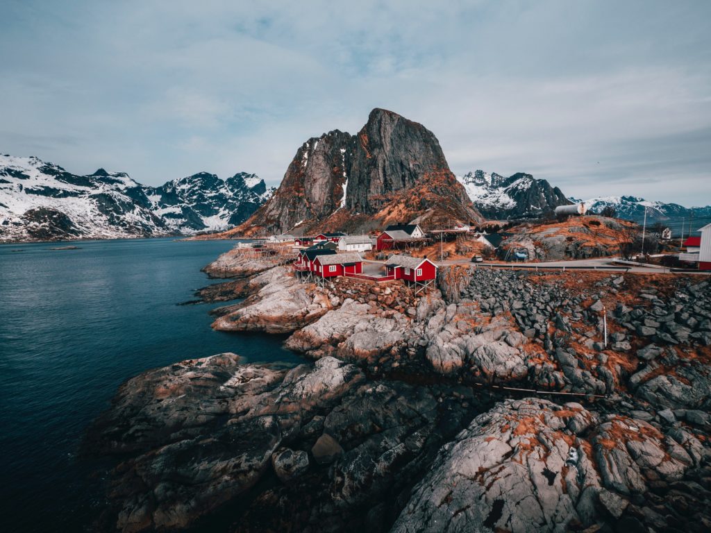 Lofoten Islands In Norway with fjords, mountains and red houses