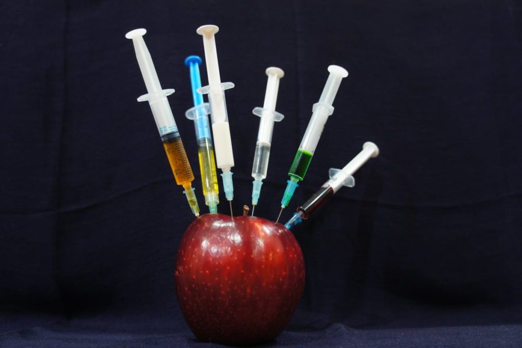 Red apple with needles stuck inside a great tip for traveling