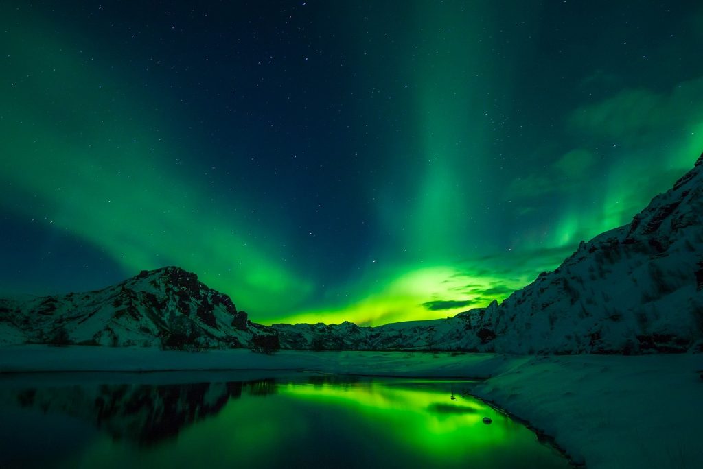 Aurora Borealis by the mountains in Iceland